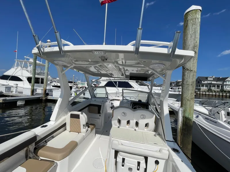 Slide: The Image of 2021 Edgewater 262 CX boat docked at marina under clear blue sky. - 35