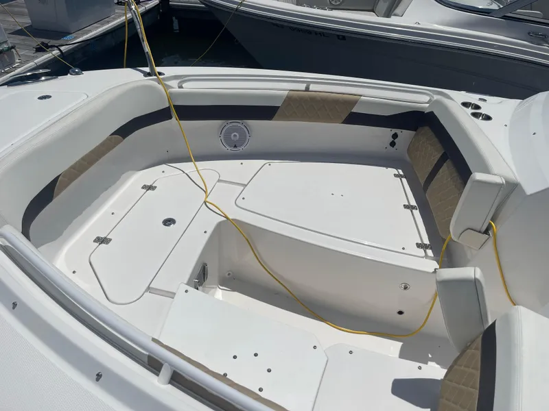 Slide: The Image of 2021 Edgewater 262 CX boat interior with seating and storage compartments. - 4