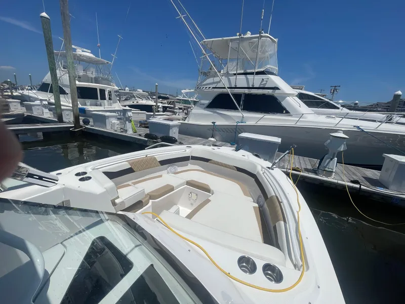 Slide: The Image of 2021 Edgewater 262 CX boat docked at marina under clear blue sky. - 8