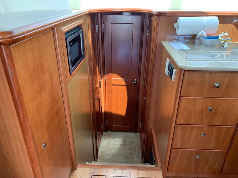 Slide: The Image of Interior of 2012 Silverton 33 Sport Coupe with wood cabinetry and microwave. - 17