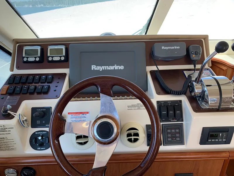 Slide: The Image of 2012 Silverton 33 Sport Coupe helm with Raymarine electronics and wooden steering wheel. - 26