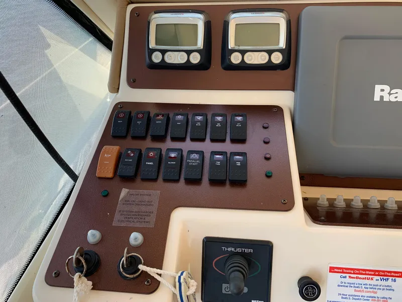 Slide: The Image of Control panel of a 2012 Silverton 33 Sport Coupe boat with switches and gauges. - 27