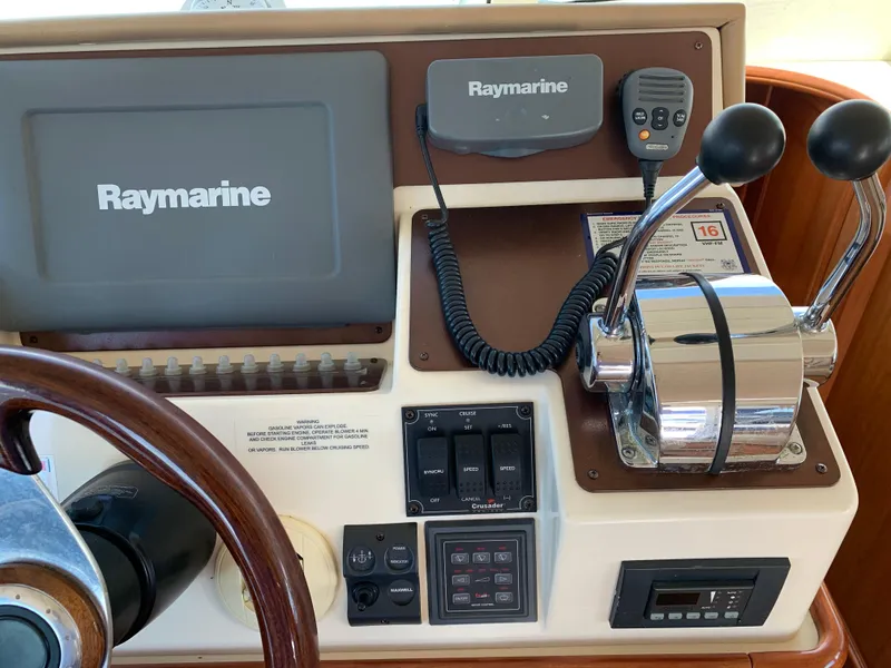 Slide: The Image of Control panel of 2012 Silverton 33 Sport Coupe with Raymarine navigation system and throttle levers. - 28