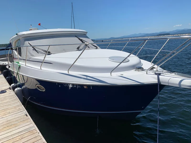 Slide: The Image of 2012 Silverton 33 Sport Coupe docked on a sunny day, with clear blue skies. - 3