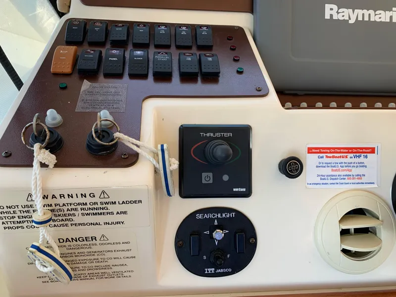 Slide: The Image of Control panel of a 2012 Silverton 33 Sport Coupe with switches and warning labels. - 30