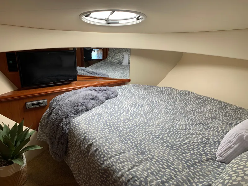 Slide: The Image of Luxurious interior of 2012 Silverton 33 Sport Coupe with cozy bedding and modern amenities. - 36