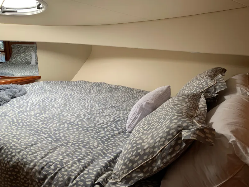 Slide: The Image of Cozy bedroom interior of 2012 Silverton 33 Sport Coupe yacht with patterned bedding. - 37