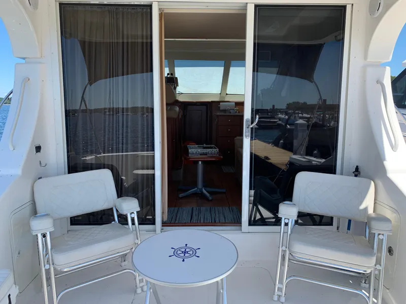 Slide: The Image of 2012 Silverton 33 Sport Coupe yacht interior with chairs and table on deck. - 4