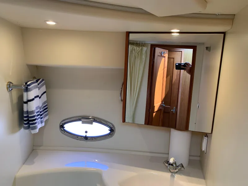 Slide: The Image of Bathroom interior of 2012 Silverton 33 Sport Coupe with mirror and towel. - 44