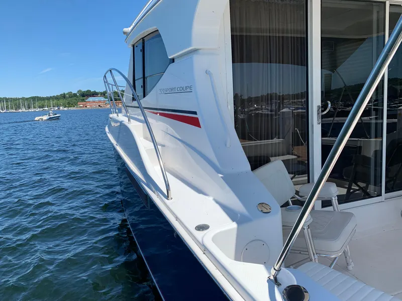 Slide: The Image of 2012 Silverton 33 Sport Coupe yacht docked on calm water. - 48