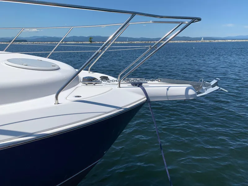 Slide: The Image of 2012 Silverton 33 Sport Coupe yacht anchored on calm blue water. - 49