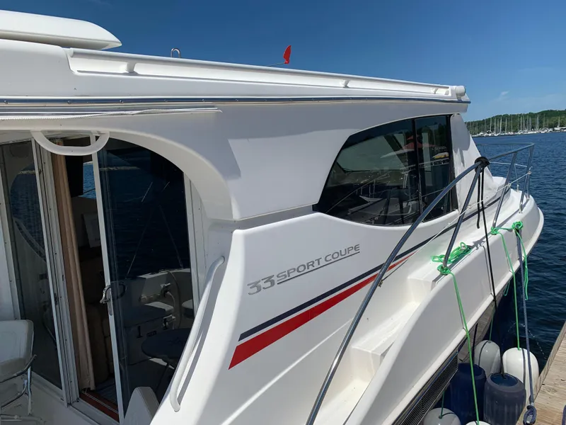 Slide: The Image of 2012 Silverton 33 Sport Coupe yacht docked, featuring sleek design and modern amenities. - 5