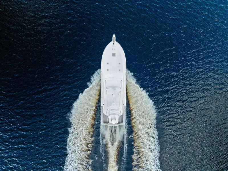 Slide: The Image of Aerial view of 2004 Bertram 570 yacht cruising on open water. - 12