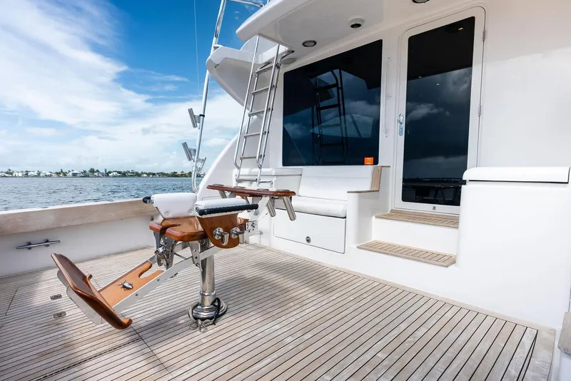 Slide: The Image of 2004 Bertram 570 yacht deck with fishing chair, ladder, and ocean view. - 14