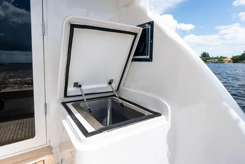 Slide: The Image of Open storage compartment on 2004 Bertram 570 yacht, with scenic water view. - 18