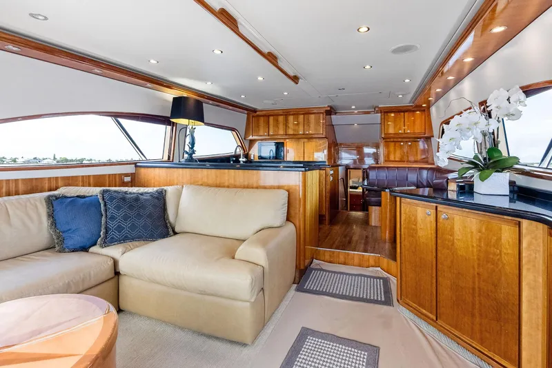 Slide: The Image of Luxurious interior of 2004 Bertram 570 yacht with elegant wood finishes and plush seating. - 25