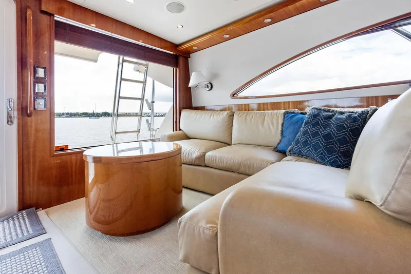 Slide: The Image of Luxurious interior of 2004 Bertram 570 yacht with plush seating and elegant wood finishes. - 26