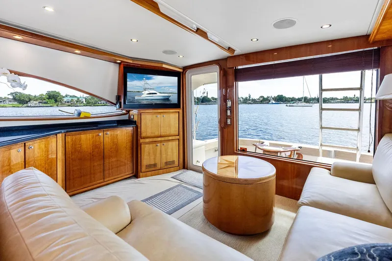 Slide: The Image of Luxurious interior of 2004 Bertram 570 yacht with leather seating and waterfront view. - 27