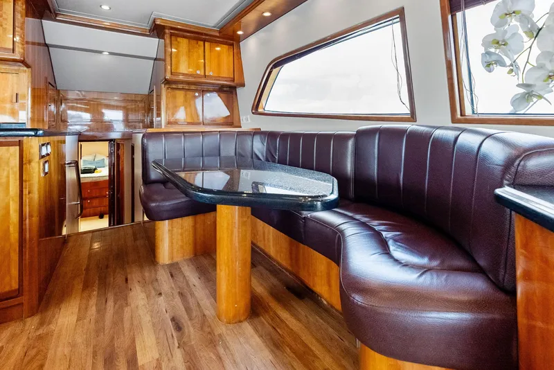 Slide: The Image of Luxurious interior of 2004 Bertram 570 yacht with leather seating and wooden finishes. - 28