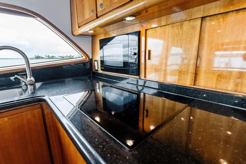 Slide: The Image of Luxurious kitchen interior of 2004 Bertram 570 yacht with sleek countertops and modern appliances. - 31
