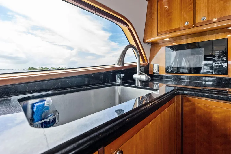 Slide: The Image of Luxurious kitchen interior of 2004 Bertram 570 yacht with modern amenities. - 32