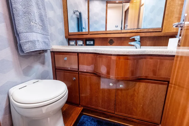 Slide: The Image of Luxurious bathroom in 2004 Bertram 570 yacht with wooden cabinetry and modern fixtures. - 36