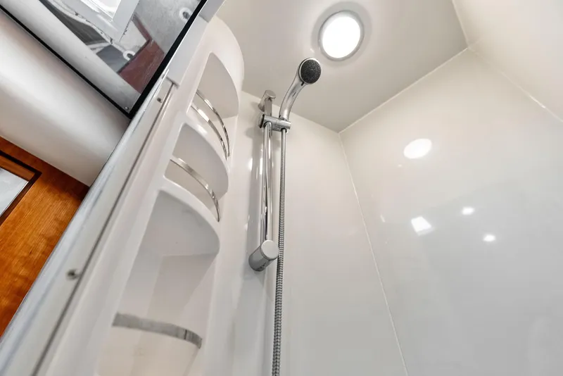 Slide: The Image of Shower area in 2004 Bertram 570 yacht, featuring modern fixtures and sleek design. - 38