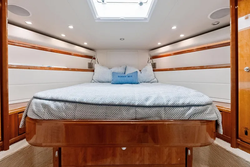 Slide: The Image of Luxurious cabin interior of 2004 Bertram 570 yacht with cozy bedding and elegant wood finish. - 40