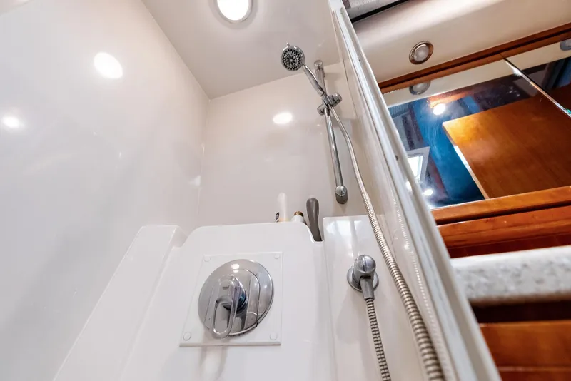 Slide: The Image of Shower area in a 2004 Bertram 570 yacht, featuring modern fixtures and lighting. - 47