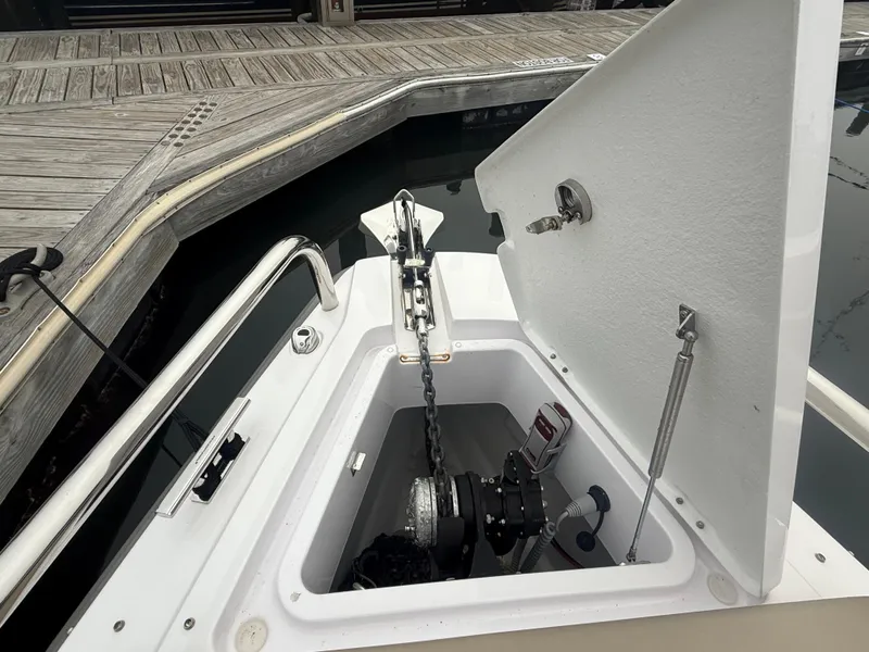 Slide: The Image of Open anchor compartment on 2023 Axopar 28 CABIN boat at dock. - 14