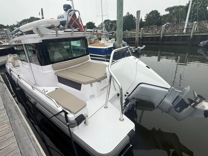 Slide: The Image of 2023 Axopar 28 CABIN boat docked, featuring sleek design and modern amenities. - 4