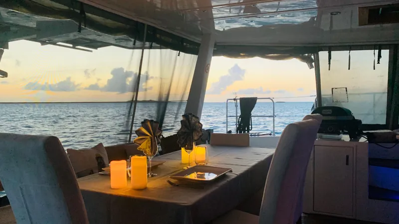 Slide: The Image of Luxurious Sunreef 62 yacht interior with elegant dining setup at sunset, 2011 model. - 11