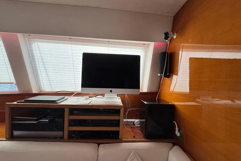 Slide: The Image of Interior of a 2011 Sunreef 62 yacht with a computer setup and wooden paneling. - 14