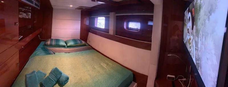 Slide: The Image of Luxurious Sunreef 62 yacht bedroom interior with elegant wood finish and ocean view windows. - 33