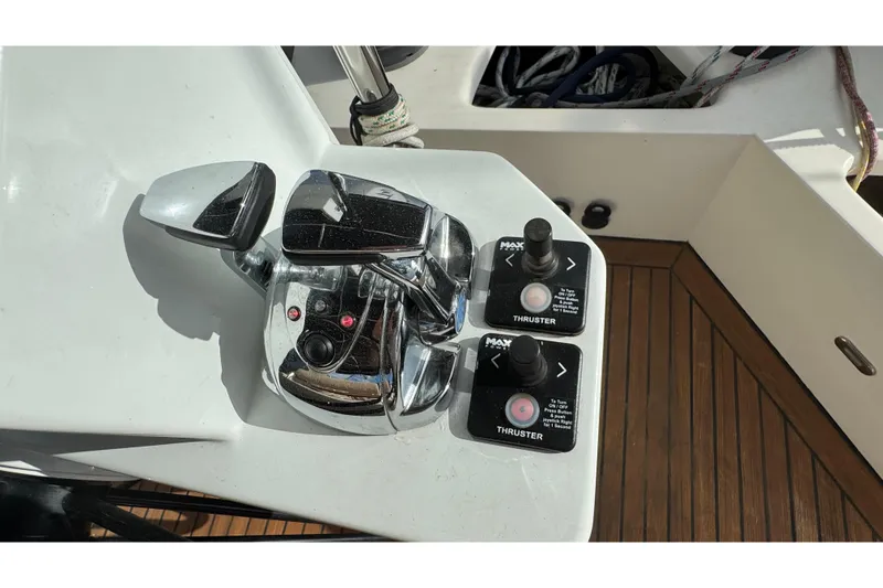 Slide: The Image of Control panel of a 2011 Sunreef 62 yacht with thruster controls and chrome levers. - 38