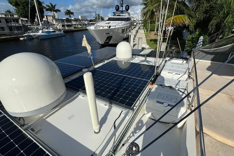 Slide: The Image of 2011 Sunreef 62 yacht with solar panels docked by waterfront homes. - 44