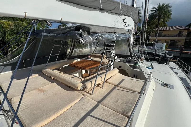 Slide: The Image of Luxurious 2011 Sunreef 62 yacht deck with cushioned seating and wooden table. - 45