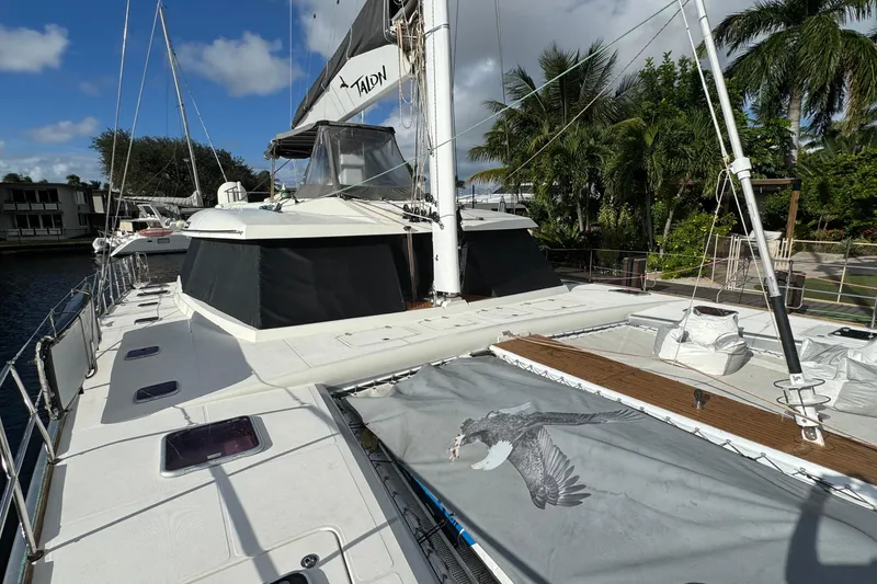 Slide: The Image of 2011 Sunreef 62 yacht docked, featuring spacious deck and tropical surroundings. - 46