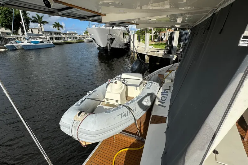 Slide: The Image of 2011 Sunreef 62 yacht with inflatable dinghy docked in a marina. - 47