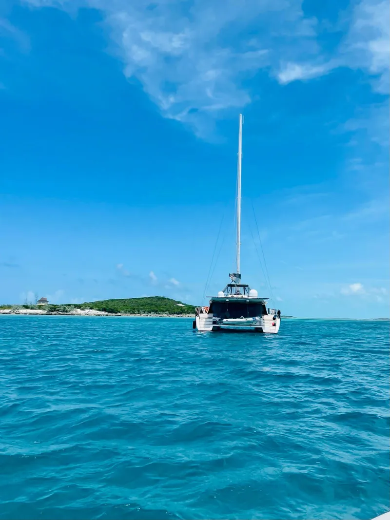 Slide: The Image of Sunreef 62 catamaran sailing on clear blue waters under a bright sky, 2011 model. - 5