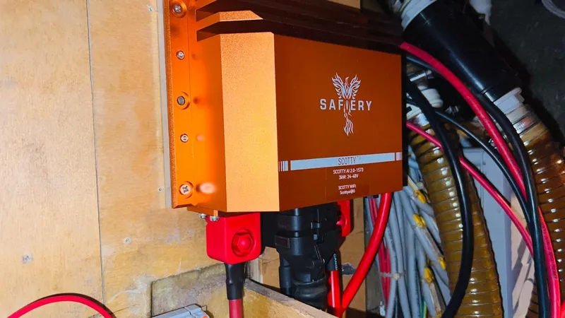 Slide: The Image of Orange Safiery device in a Sunreef 62 yacht, 2011 model, with cables and wooden paneling. - 56