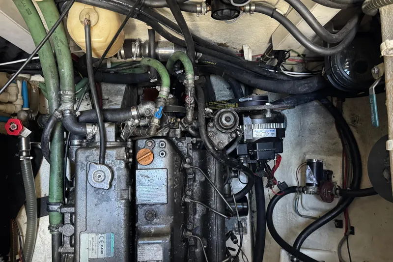 Slide: The Image of Engine room of a 2011 Sunreef 62 yacht, showcasing complex machinery and hoses. - 57