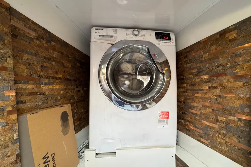 Slide: The Image of Washing machine in a Sunreef 62 yacht, 2011 model, with stone-textured walls. - 60