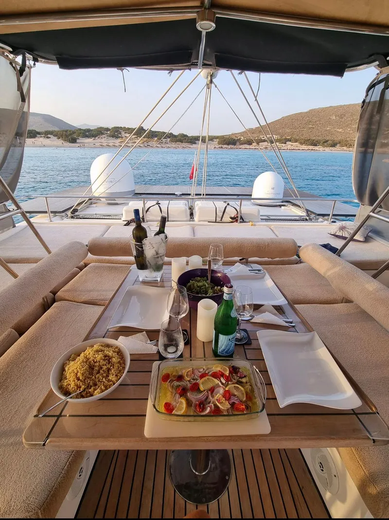 Slide: The Image of Luxurious dining setup on a 2011 Sunreef 62 yacht, overlooking serene blue waters. - 8