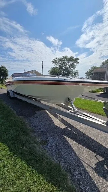 The Image of 1989 Fountain 36 Fever speedboat on trailer under a clear blue sky. - 0
