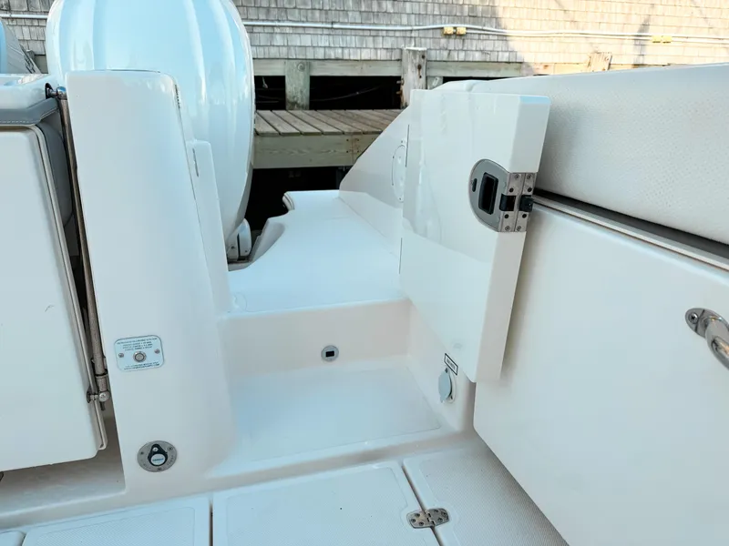 Slide: The Image of 2022 Pursuit DC 365 Dual Console boat interior with open storage compartment. - 10
