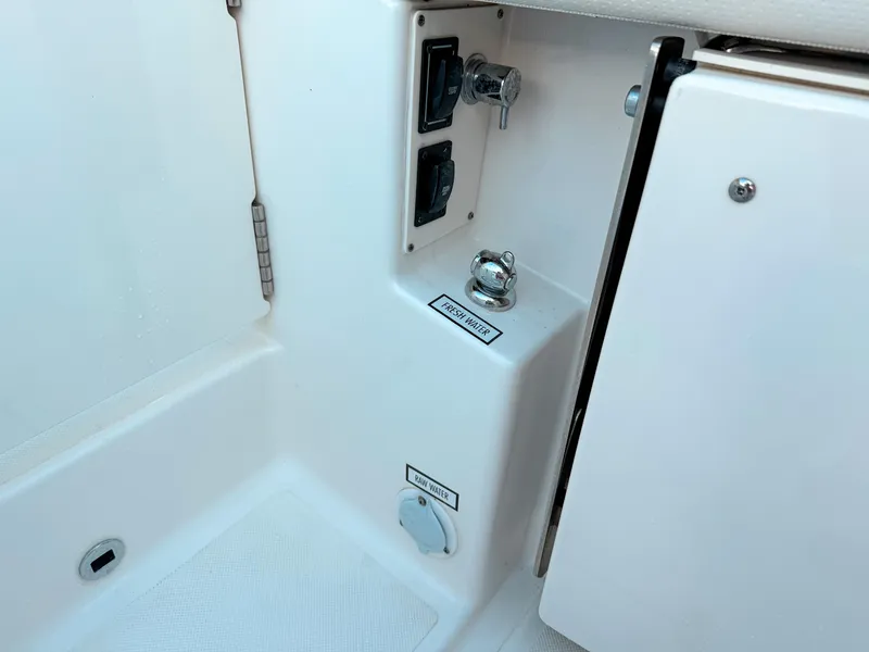 Slide: The Image of 2022 Pursuit DC 365 Dual Console boat interior with fresh water access. - 12