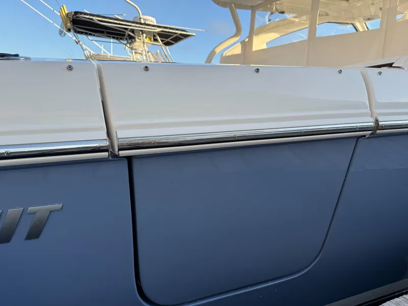 Slide: The Image of 2022 Pursuit DC 365 Dual Console boat, close-up of sleek exterior design. - 13