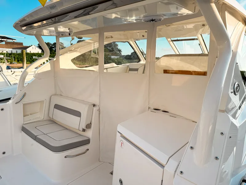 Slide: The Image of 2022 Pursuit DC 365 Dual Console boat interior with seating and storage. - 16