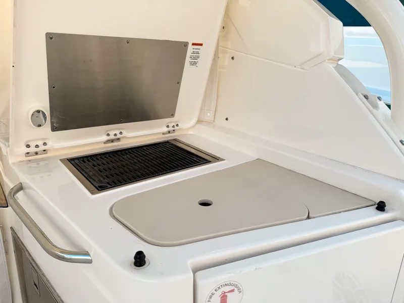 Slide: The Image of Outdoor kitchen area on a 2022 Pursuit DC 365 Dual Console boat. - 18